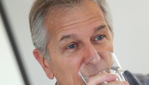 Photo of man drinking a glass of water