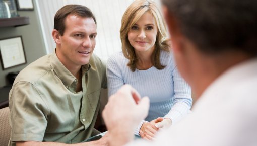 Photo of a couple talking with their doctor