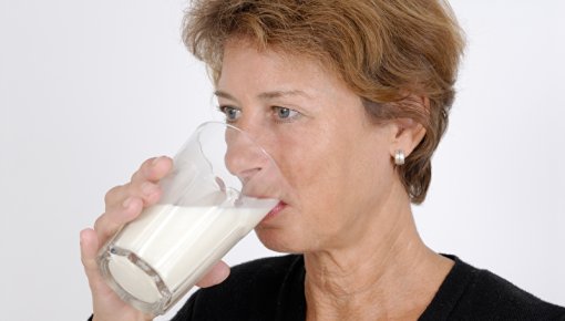 A woman drinking a glass of milk