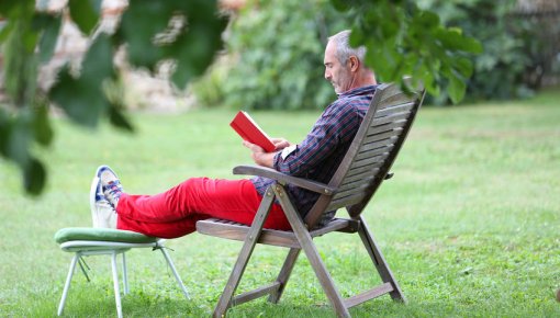 Photo of man reading in garden