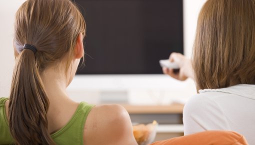 Photo of a mother and daughter watching TV