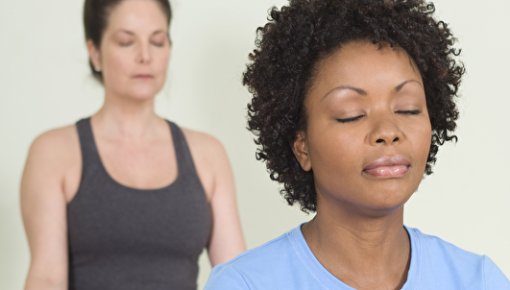 Photo of two women doing yoga