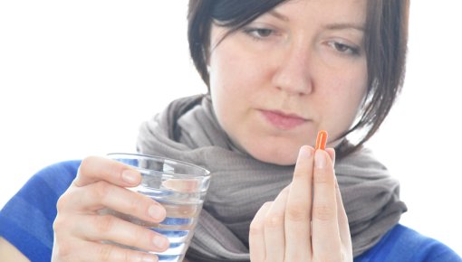 Photo of woman taking medication