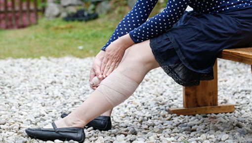 Photo of a woman with her hands on her leg