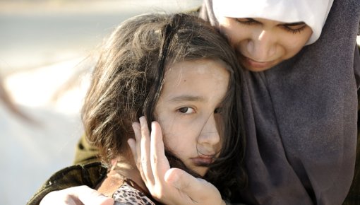 Photo of a traumatized girl with her mother
