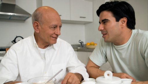 Photo of two men talking at the breakfast table