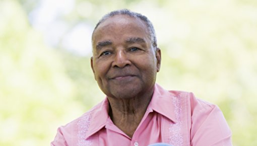 Photo of a man sitting on the grass