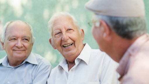Photo of three older men talking