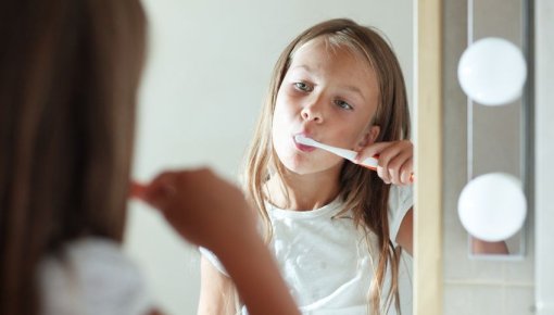 Photo of a girl brushing her teeth