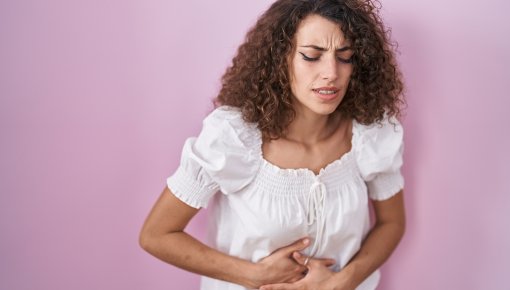 Photo of woman holding her belly in pain