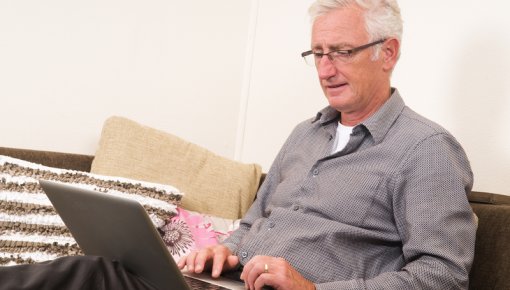 Photo of a man with a laptop