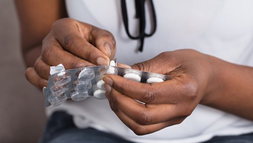 Photo of someone taking tablets out of the package