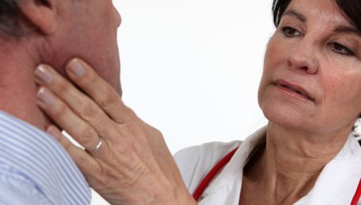 Photo of a doctor examining a man’s face