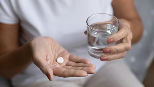 Photo of woman taking medication