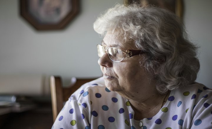 Photo of elderly woman sitting on chair