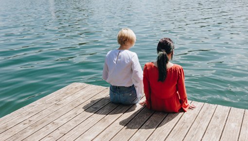 Photo of two women by a lake