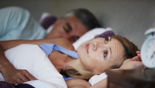 Photo of a woman lying awake in bed