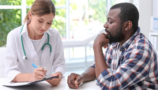 A young man talking to a doctor