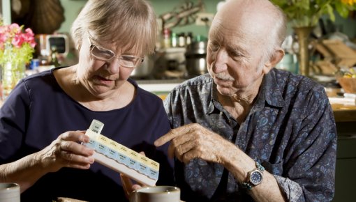 Photo of a couple with a pill organizer