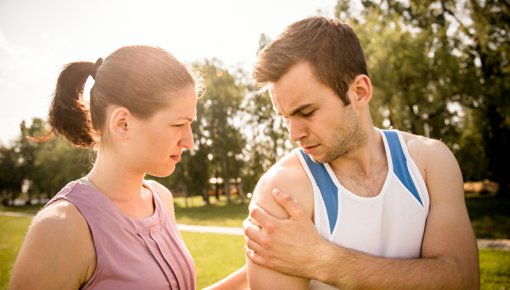 Photo of an athlete holding his shoulder in discomfort