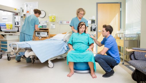 Photo of pregnant woman and her partner in delivery room