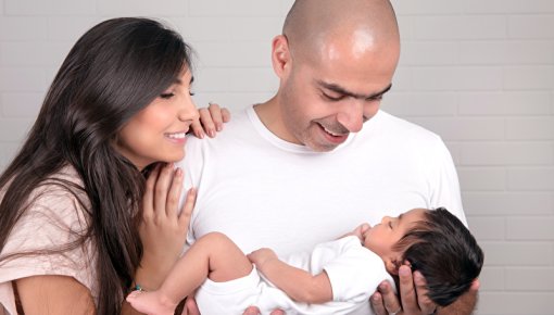 Photo of a couple with their baby