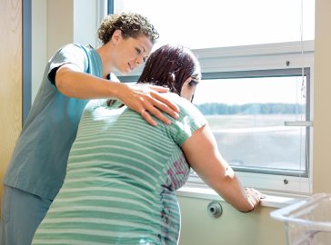 Photo of a pregnant woman and a nurse