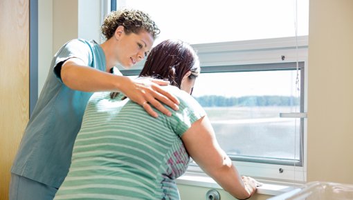 Photo of a pregnant woman and a nurse