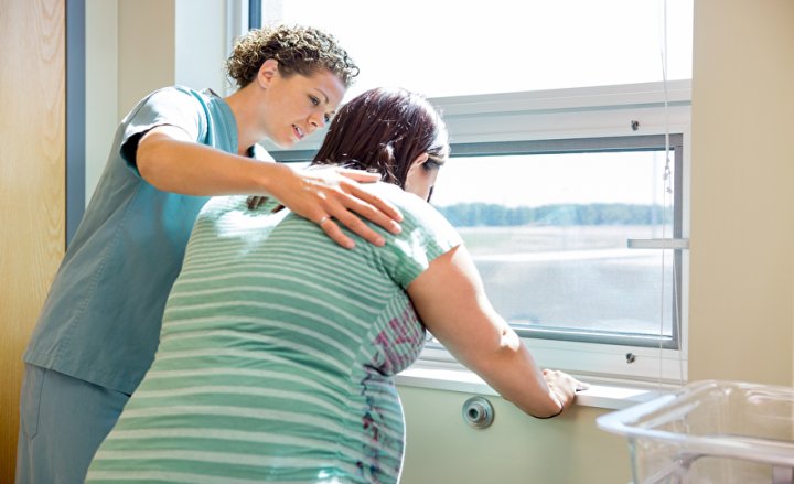 Photo of a pregnant woman and a nurse