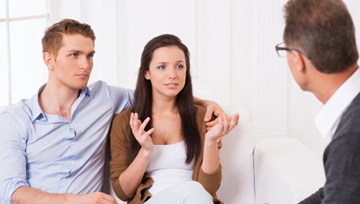 Photo of a young couple and a doctor at a consultation 