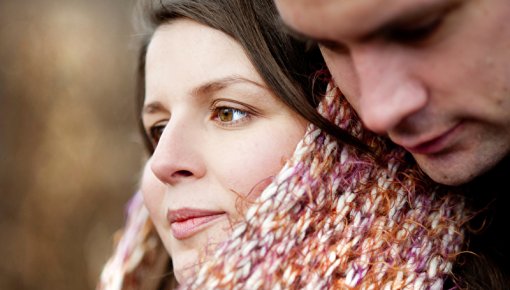Young pregnant woman and partner outdoors on an autumn day