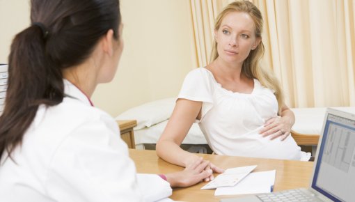 Photo of a pregnant woman and her doctor