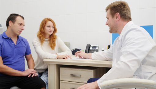 Photo of a couple talking with a doctor