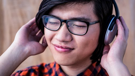 Photo of teenager listening to music through headphones