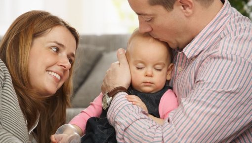 Photo of a couple with their baby