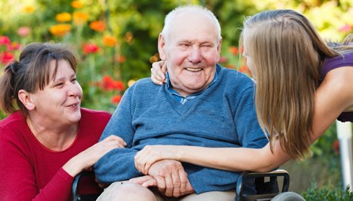 Photo of a grandfather surrounded by family