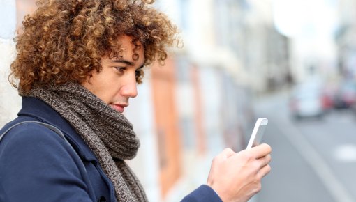 Photo of a young man using a smartphone