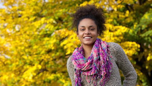 Young smiling woman with trees in background