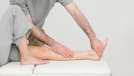 Photo of a physiotherapist treating a sprained ankle