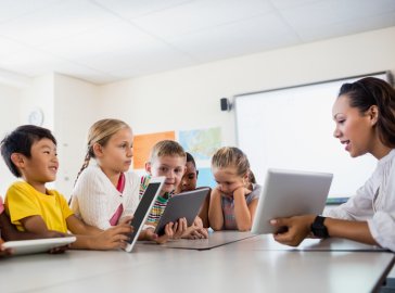 Photo of a school teacher giving a lesson