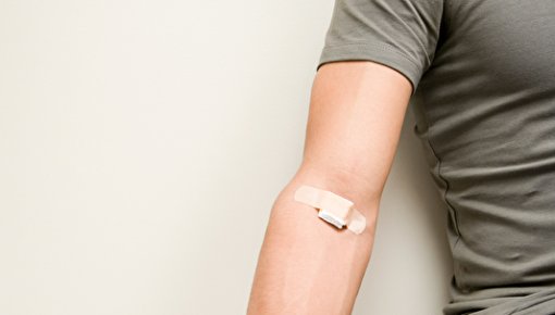 Photo of a man having blood taken