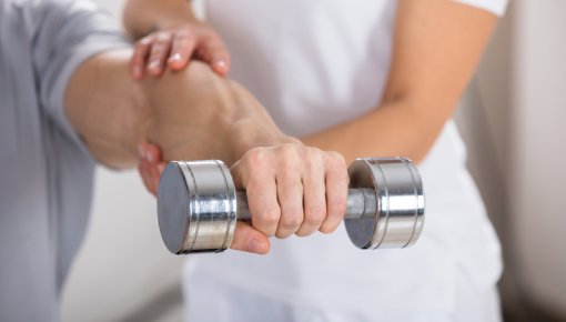 Photo of a man doing exercises with weights