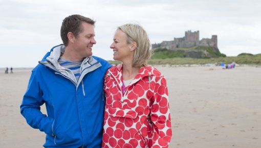 Photo of a couple taking a stroll along the beach