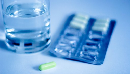 Photo of pills and a glass of water