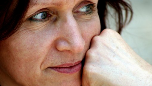 Photo of a woman resting her chin on her hand