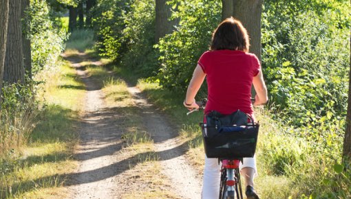 Photo of a woman on a bike path