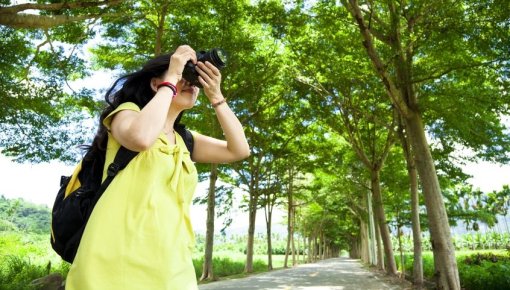 Photo of a woman holding a camera