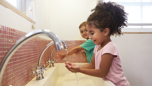 Photo of young children washing their hands