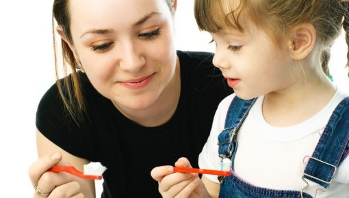 Photo of a mother and child brushing their teeth