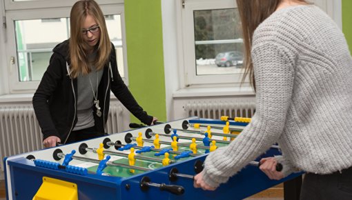 Photo of two teenage girls playing table football